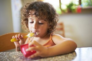 Toddler eating yogurt