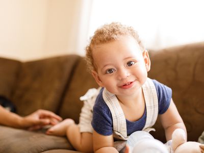 toddler boy with big eyes and a smile