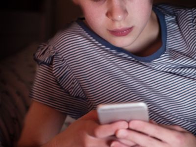 young teen looking at smartphone