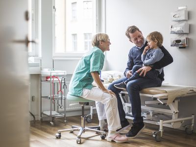 Father and son talking to doctor