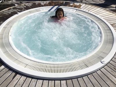 Young girl relaxing in jacuzzi
