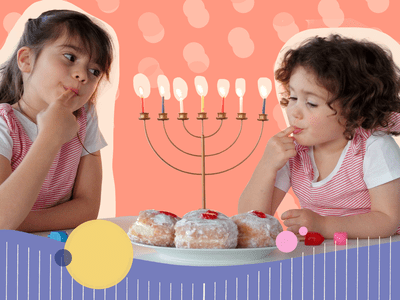 Two girls eating dessert by menorah