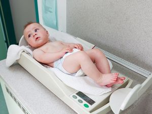 儿科医生给女婴称重