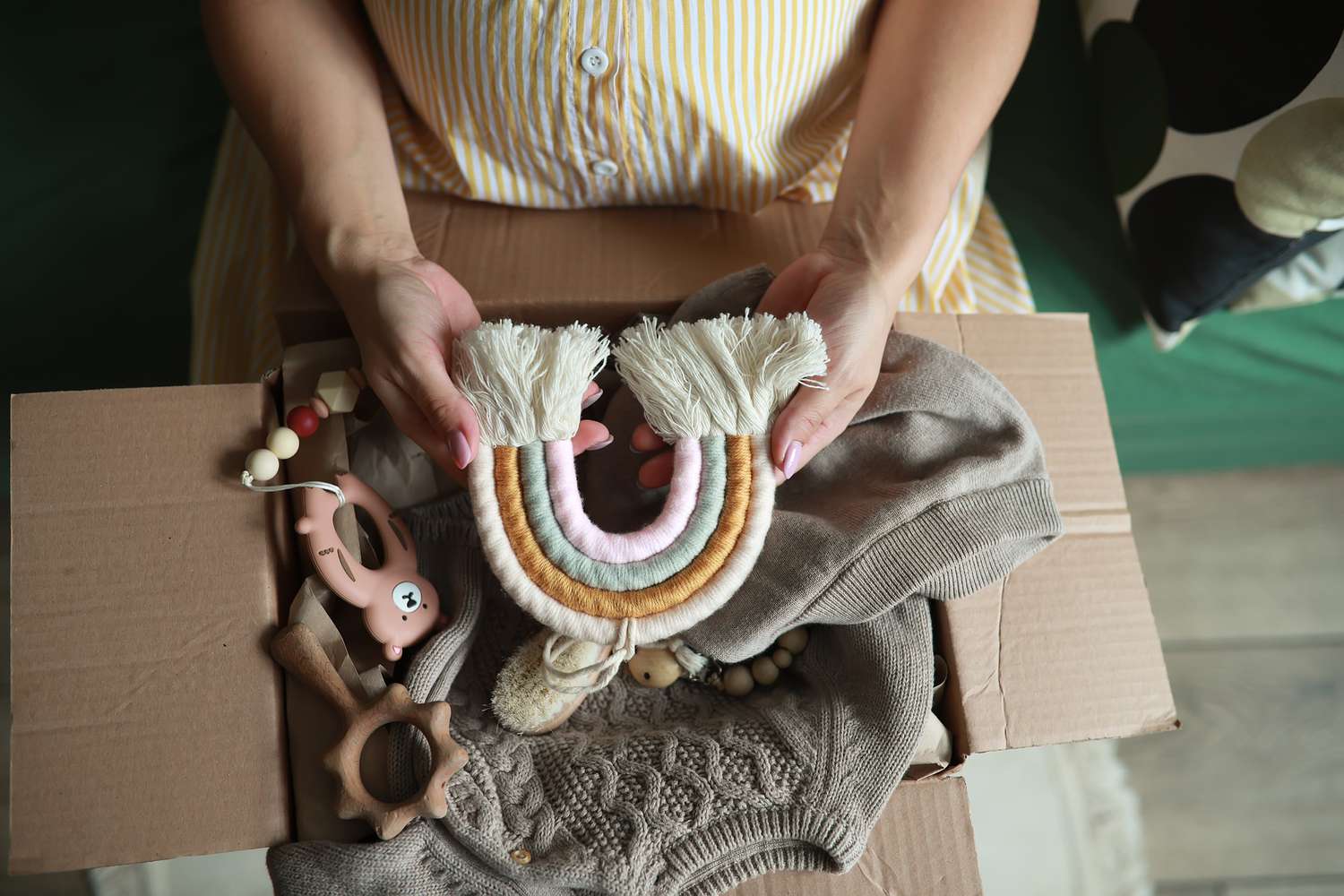 Young pregnant woman with parcel with things for newborn