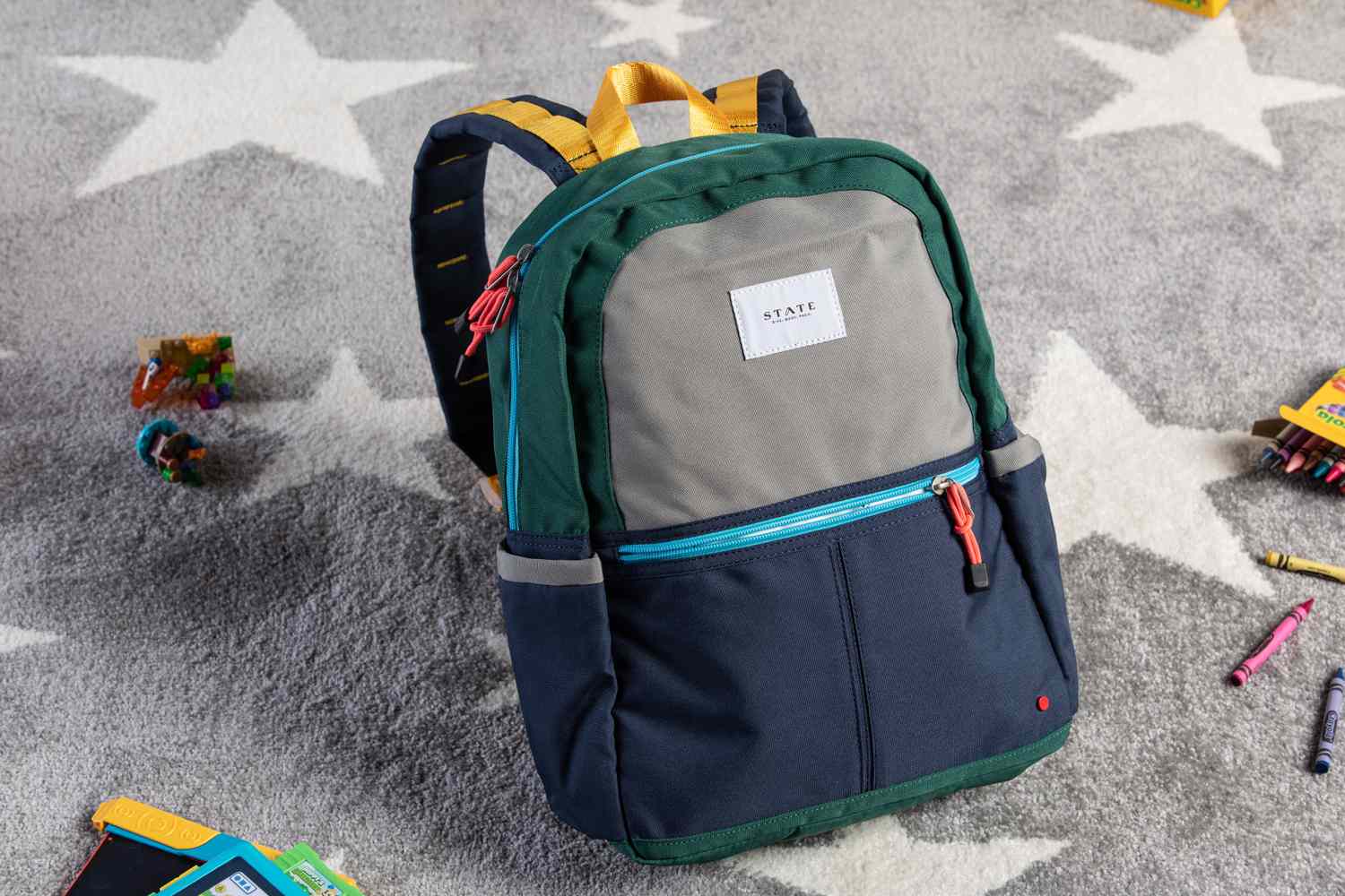 State Kane kids double pocket backpack displayed on carpet