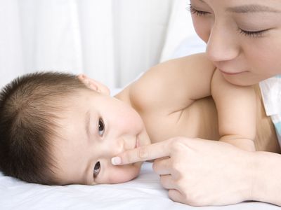 Mother and baby boy on bed