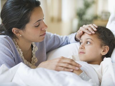 Mother comforting her child in bed.