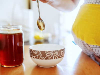 Pregnant woman eating honey