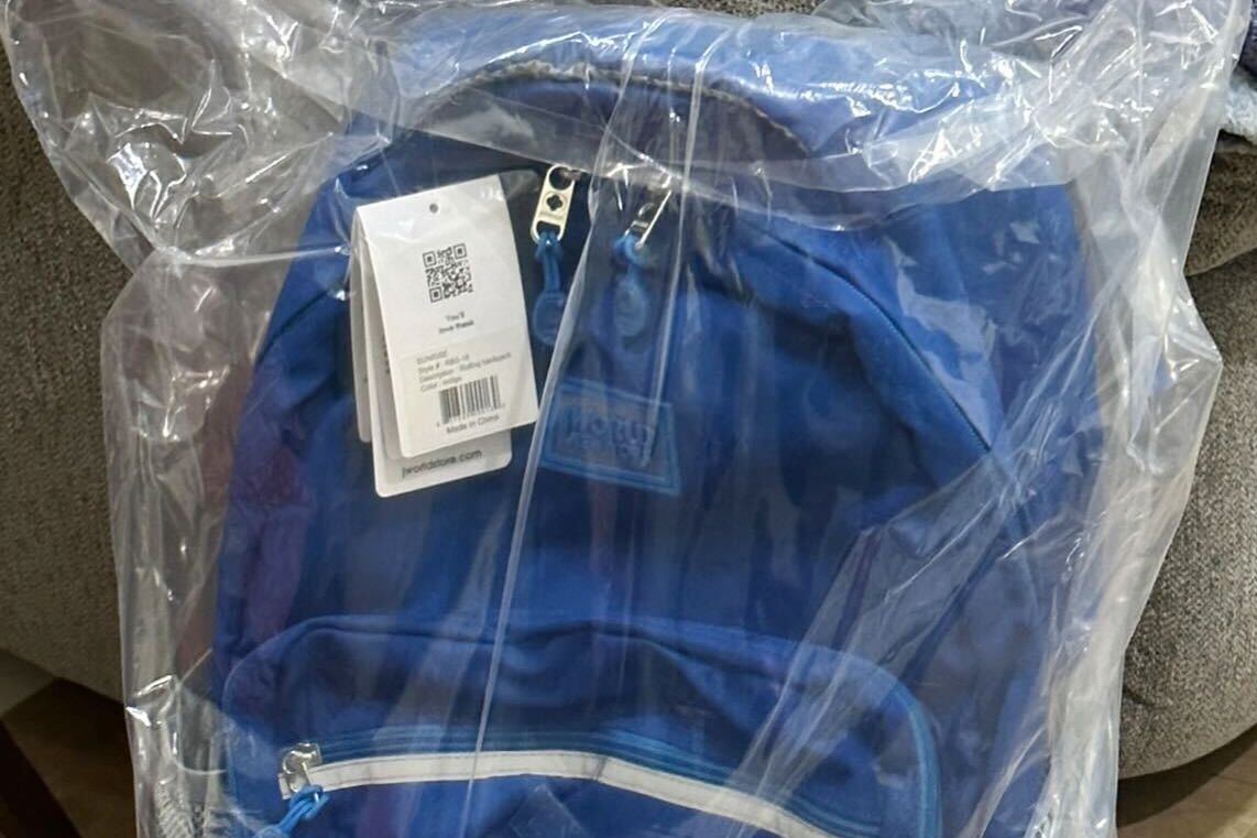 JWorld Sunrise Rolling Backpack inside plastic wrap