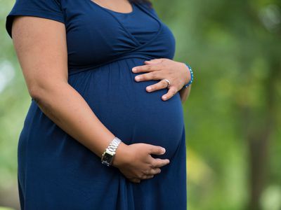Pregnant woman holds her belly