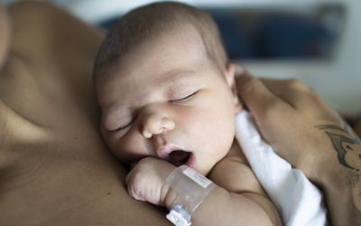 newborn baby skin to skin with caregiver
