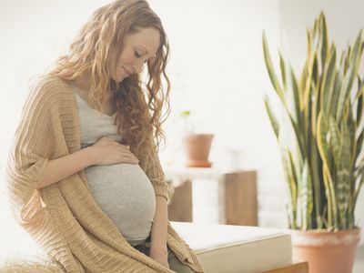 Pregnant woman holding stomach
