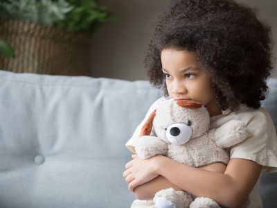 stressed out young child holding stuffed animal