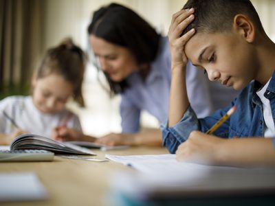 Mother helping her kids with homework