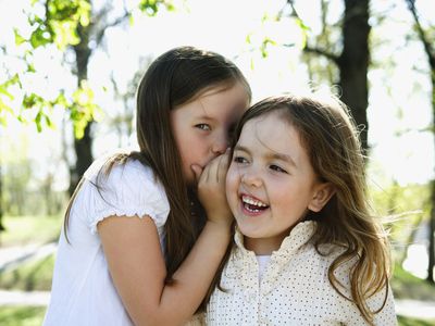 Two girls whispering