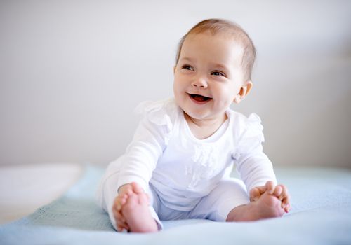 Smililng baby sitting up