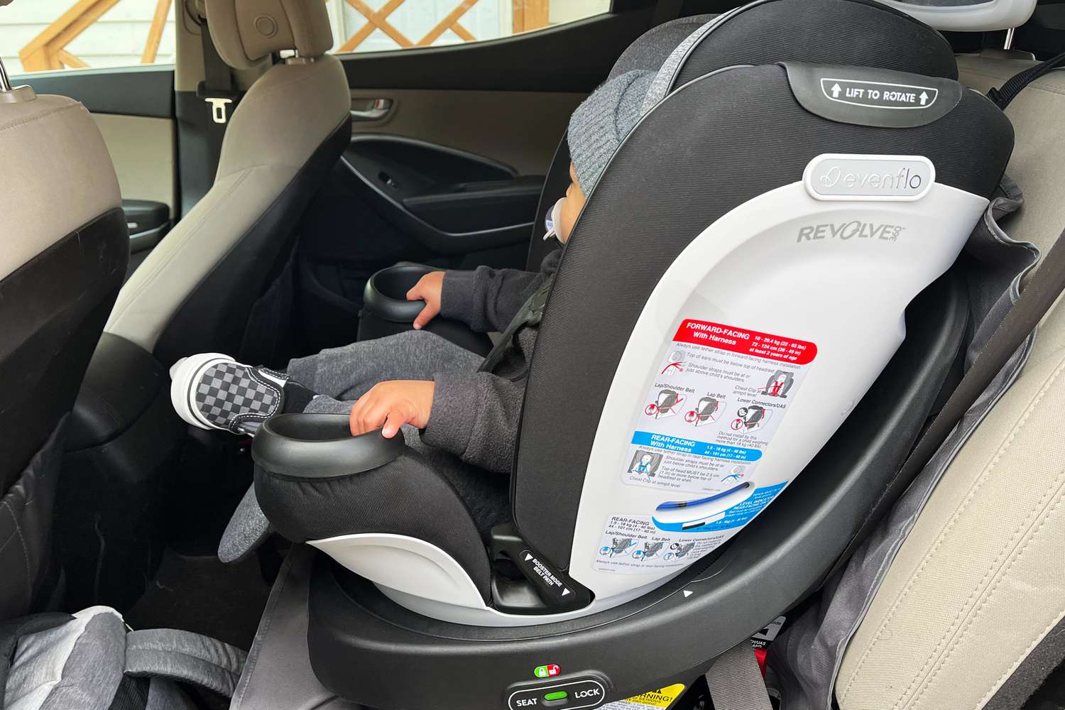 Child sitting in the Evenflo Gold Revolve360 Rotational All-In-One Convertible Car Seat