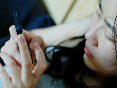 Upset teen on smartphone