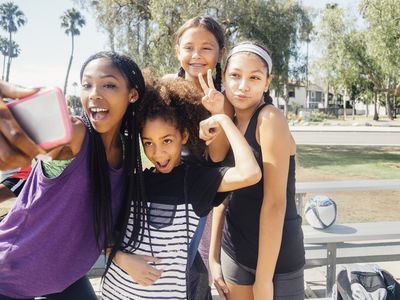 Tween girls taking selfie