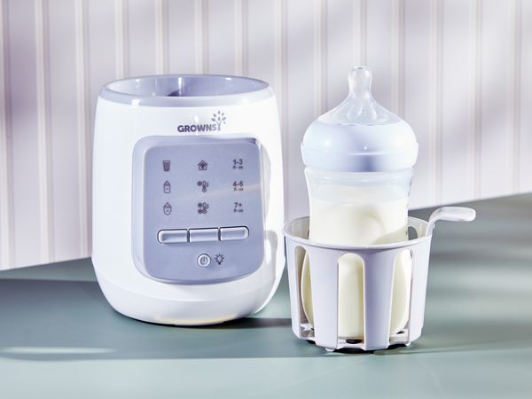 baby bottle with milk in a bottle warmer