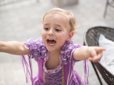 excited kid dressed in princess dress