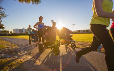 Mothers jogging in park with pushchairs