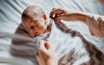 Baby being swaddled