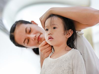 mom cleaning child's ear