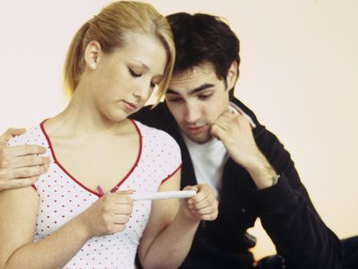 Young couple looking at a negative pregnancy test