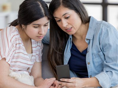mother and daughter talking and looking online