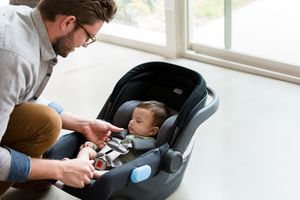 dad with newborn car seat