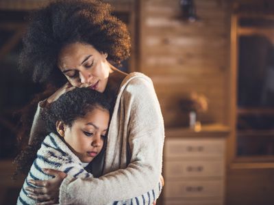 Black mother embraces child
