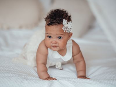 Portrait Of Cute Baby On Bed