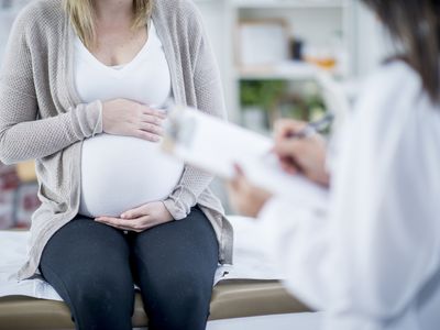 Pregnant woman holding stomach