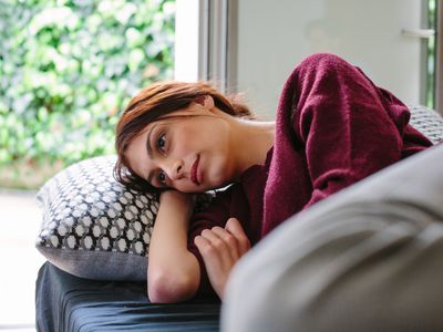 sad woman on couch