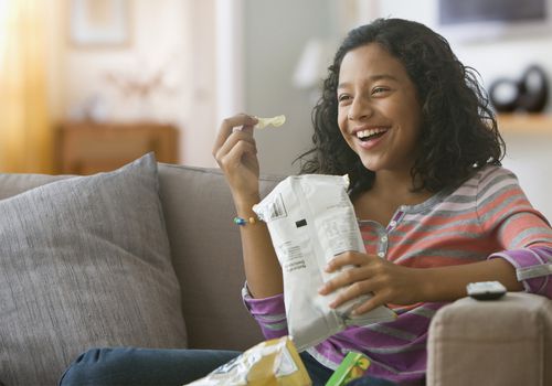 Tween girl eating chips
