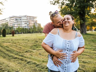 Cheerful couple embracing in the park