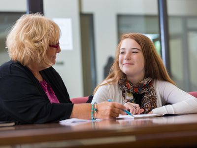 Preteen student meeting with school counselor or therapist