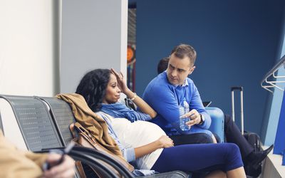Pregnant woman getting ready to fly