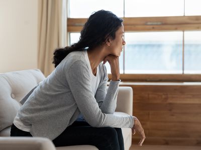 Woman sitting on sofa at home