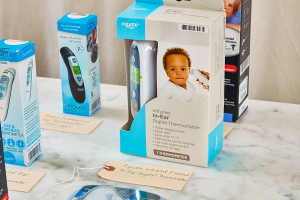 Several baby thermometers displayed on a marbled surface