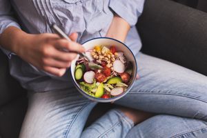 Teen eating a bowl of vegetables