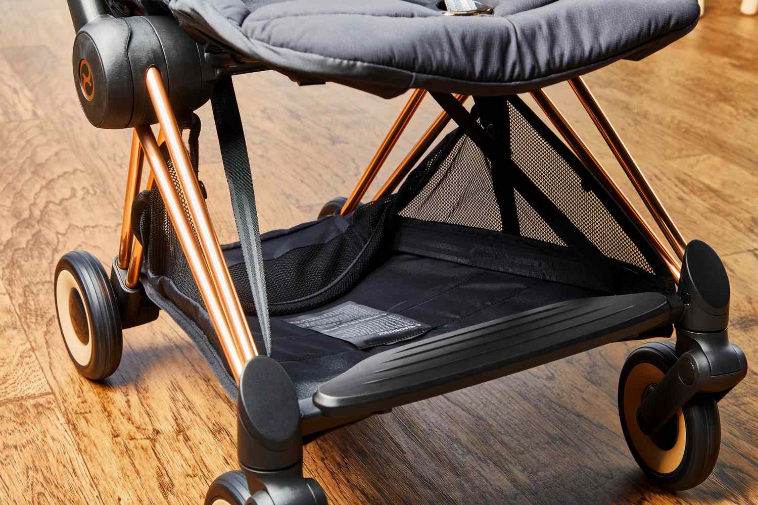 Detail of the bottom shelf storage on a CYBEX Coya stroller.