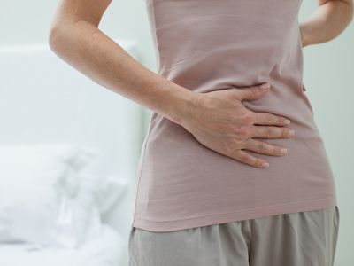 Woman rubbing aching stomach