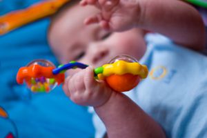 Baby playing with rattle