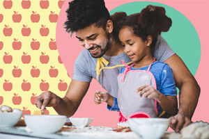 Father helping daughter cook