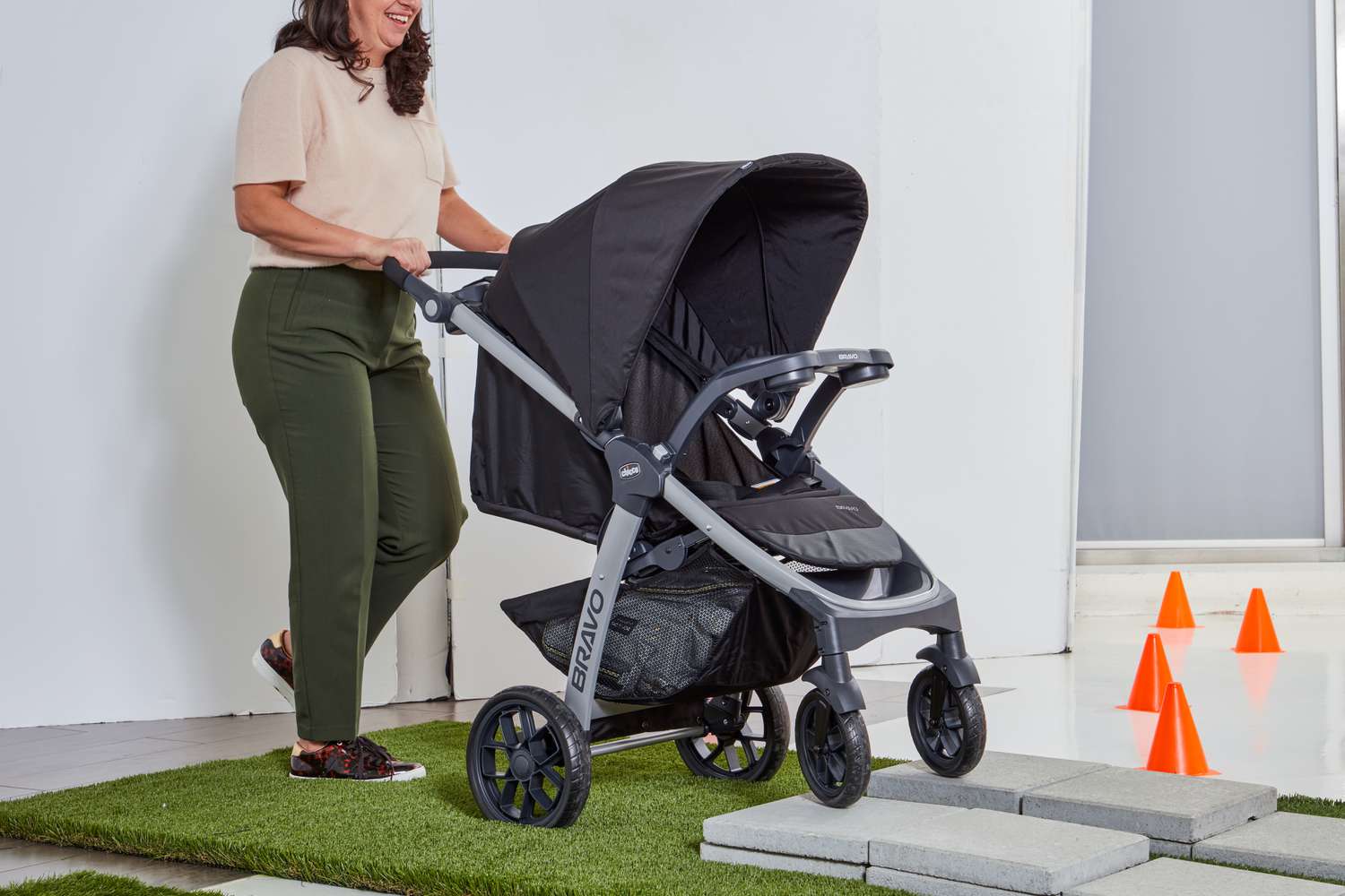 Women walking Chicco Bravo Trio Travel System on stone surface