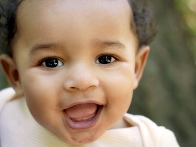 Baby of African American descent looking at the camera, close-up