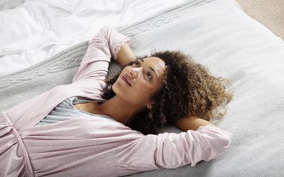 Woman relaxing on bed after sex