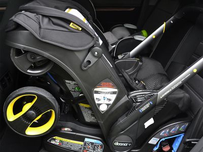 Close-up of a Doona Infant Car Seat & Stroller installed in a car